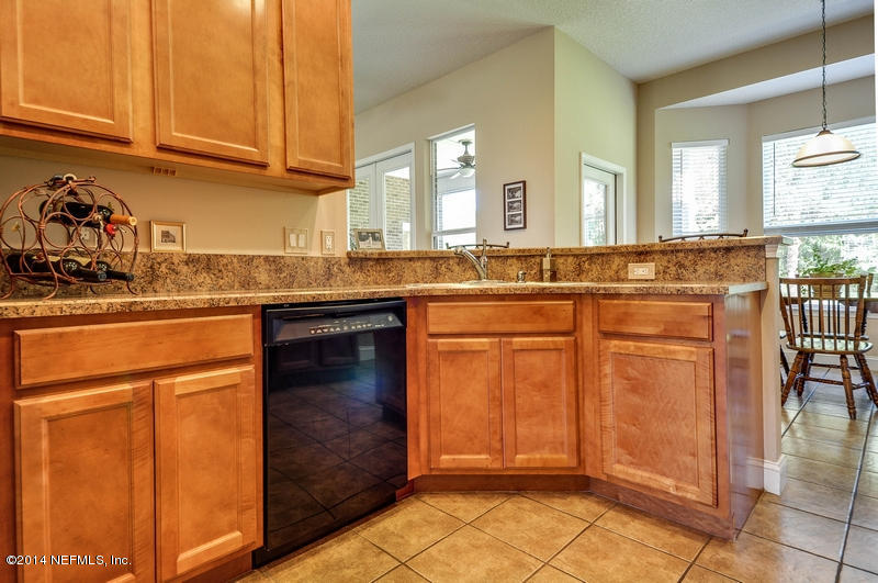 55108 Bear Run Road Callahan, FL 32011 - Photo 13 of 33 a kitchen with stainless steel appliances granite countertop a sink and cabinets