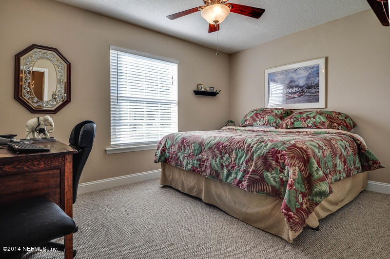 55108 Bear Run Road Callahan, FL 32011 - Photo 21 of 33 a bedroom with a bed a dresser next to a window
