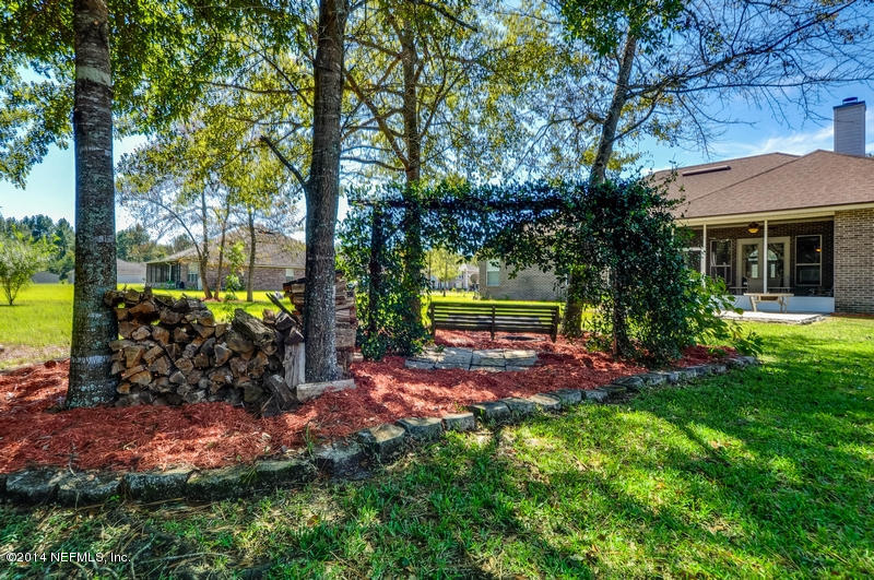 55108 Bear Run Road Callahan, FL 32011 - Photo 27 of 33 a view of a yard with plants and tree