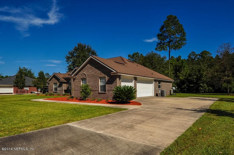 55108 Bear Run Road Callahan, FL 32011 - Photo 30 of 33 a front view of a house with a yard and garage