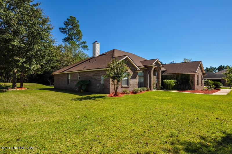 55108 Bear Run Road Callahan, FL 32011 - Photo 32 of 33 a front view of a house with a garden and porch