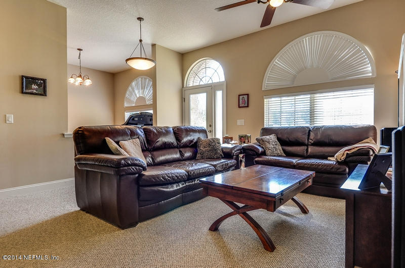 55108 Bear Run Road Callahan, FL 32011 - Photo 5 of 33 a living room with furniture a large window and a chandelier