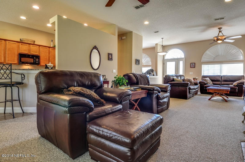 55108 Bear Run Road Callahan, FL 32011 - Photo 6 of 33 a living room with furniture a large window and a chandelier