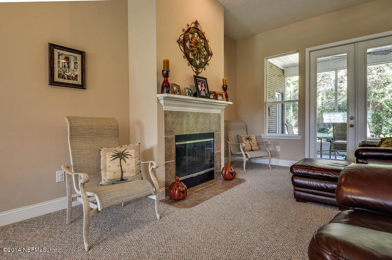 55108 Bear Run Road Callahan, FL 32011 - Photo 8 of 33 a living room with furniture a fireplace and a large window