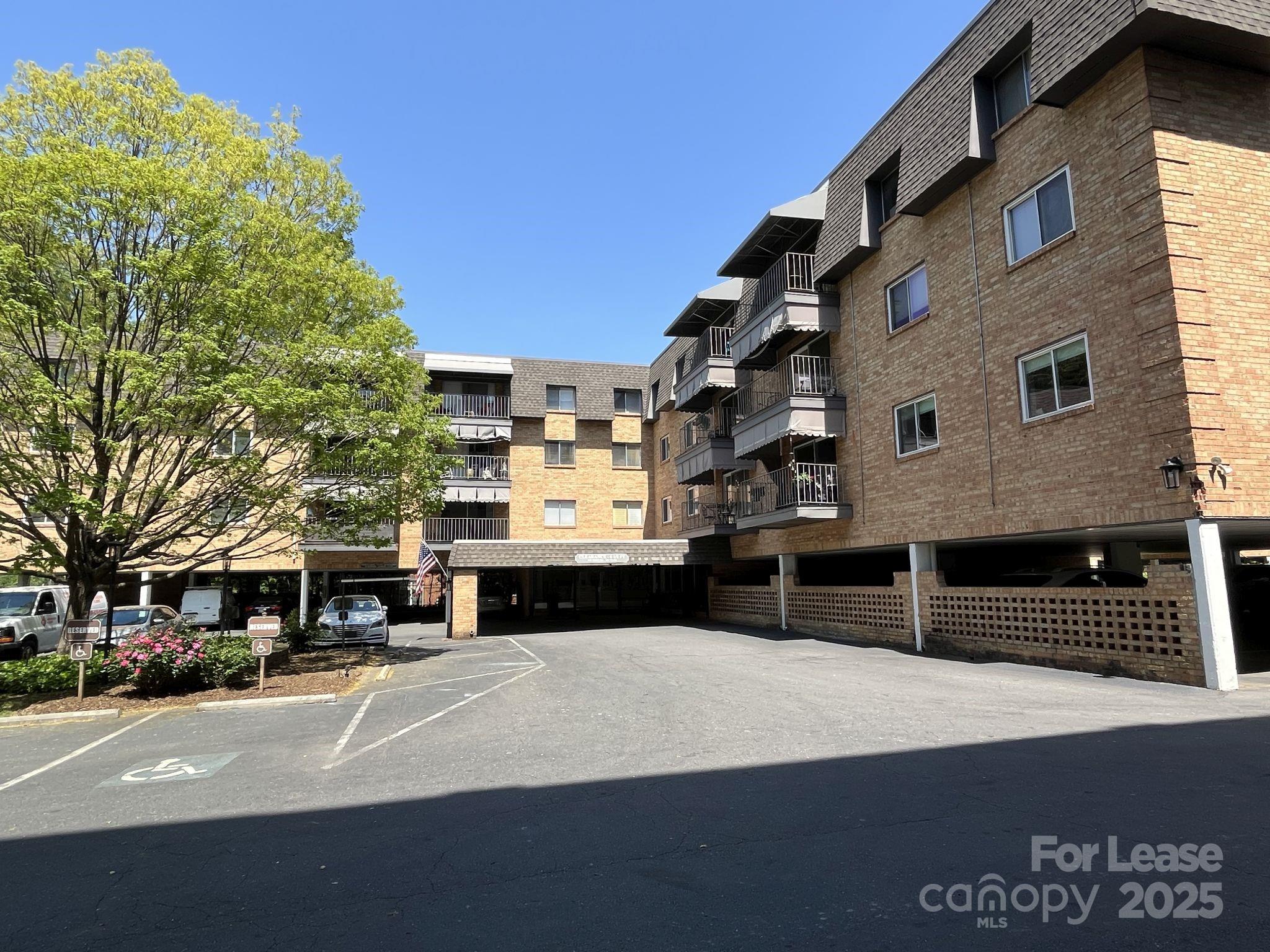 a front view of a building with parking space