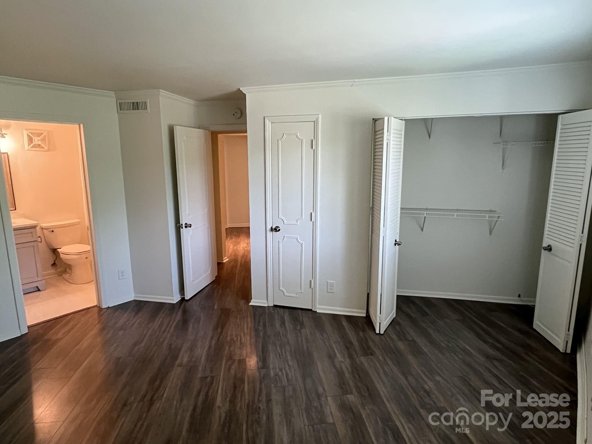 1323 Queens Road, Unit 312 Charlotte, NC 28207 - Photo 15 of 32 an empty room with wooden floor and a window