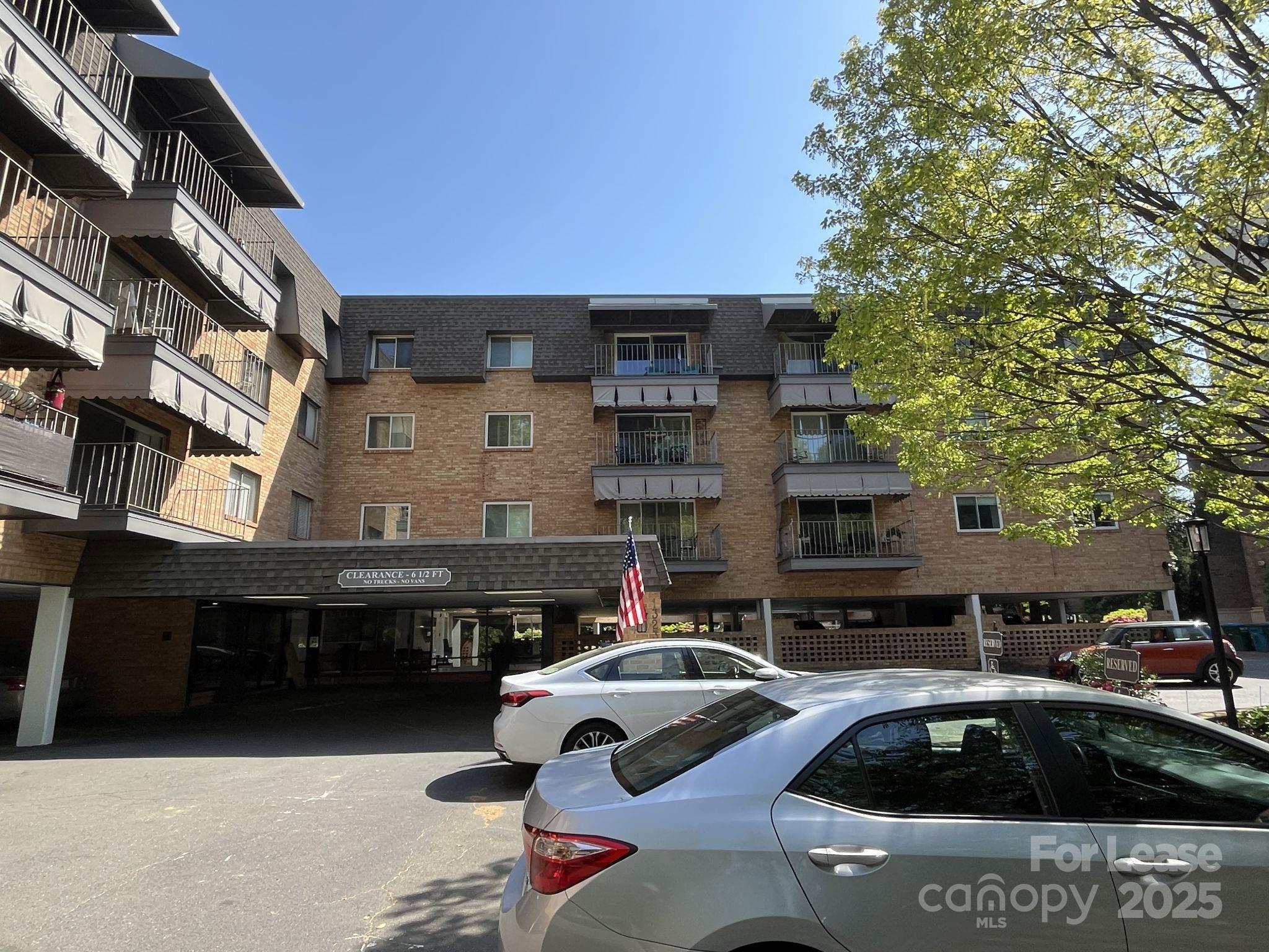 1323 Queens Road, Unit 312 Charlotte, NC 28207 - Photo 2 of 32 a front view of residential houses and cars parked on road