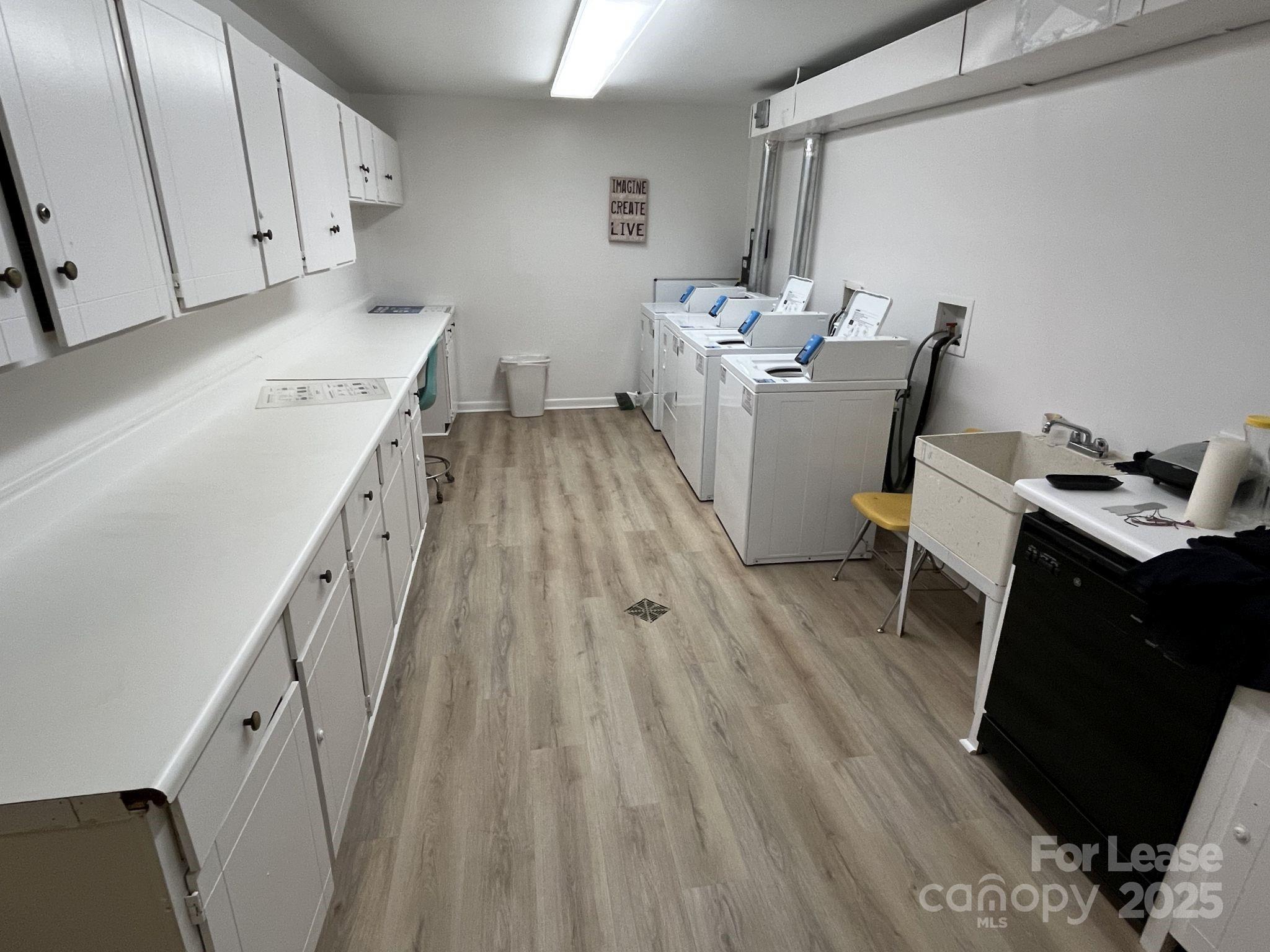 1323 Queens Road, Unit 312 Charlotte, NC 28207 - Photo 25 of 32 a living room with furniture and a wooden floor