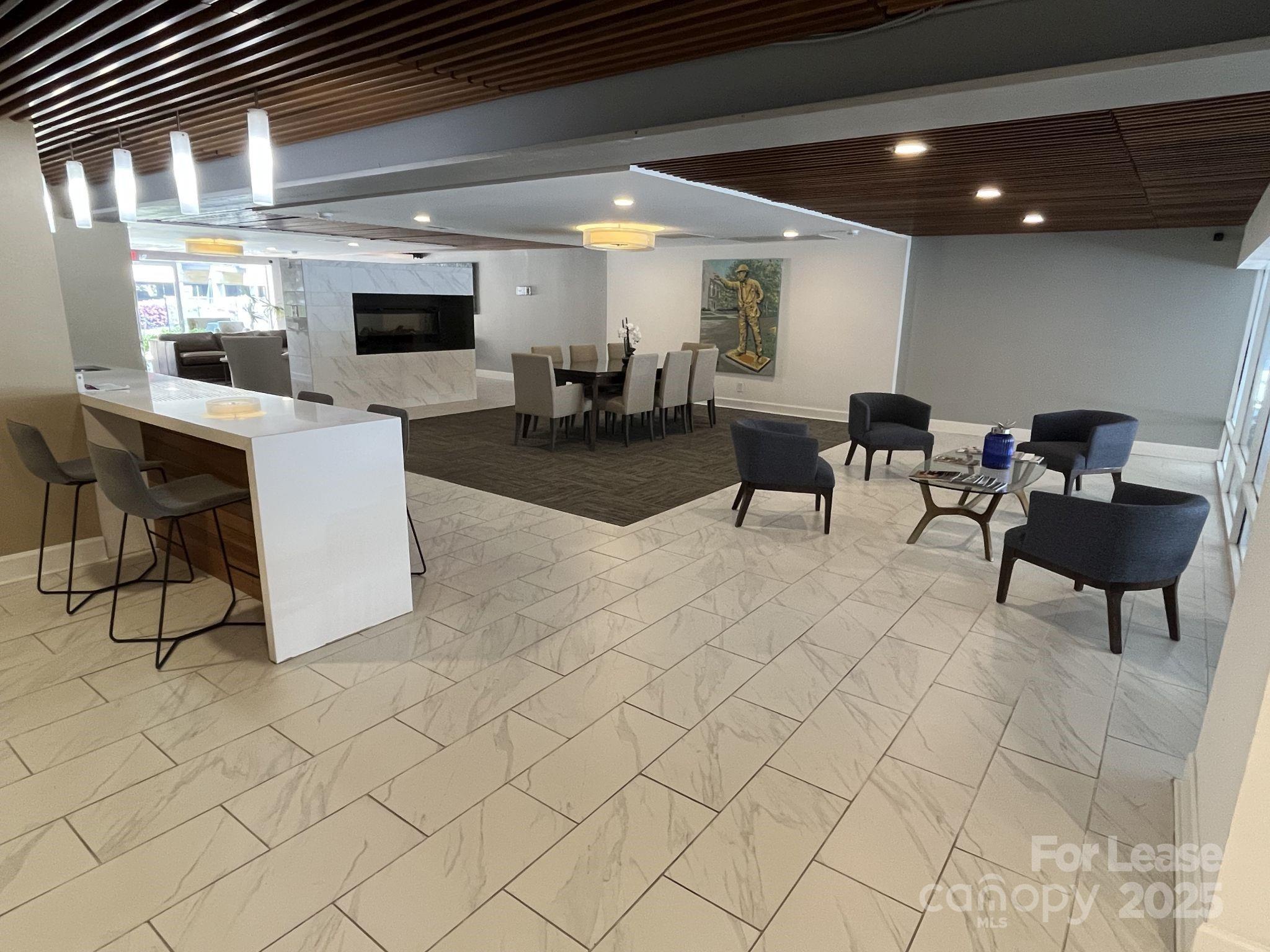 1323 Queens Road, Unit 312 Charlotte, NC 28207 - Photo 27 of 32 a living room with furniture and a flat screen tv