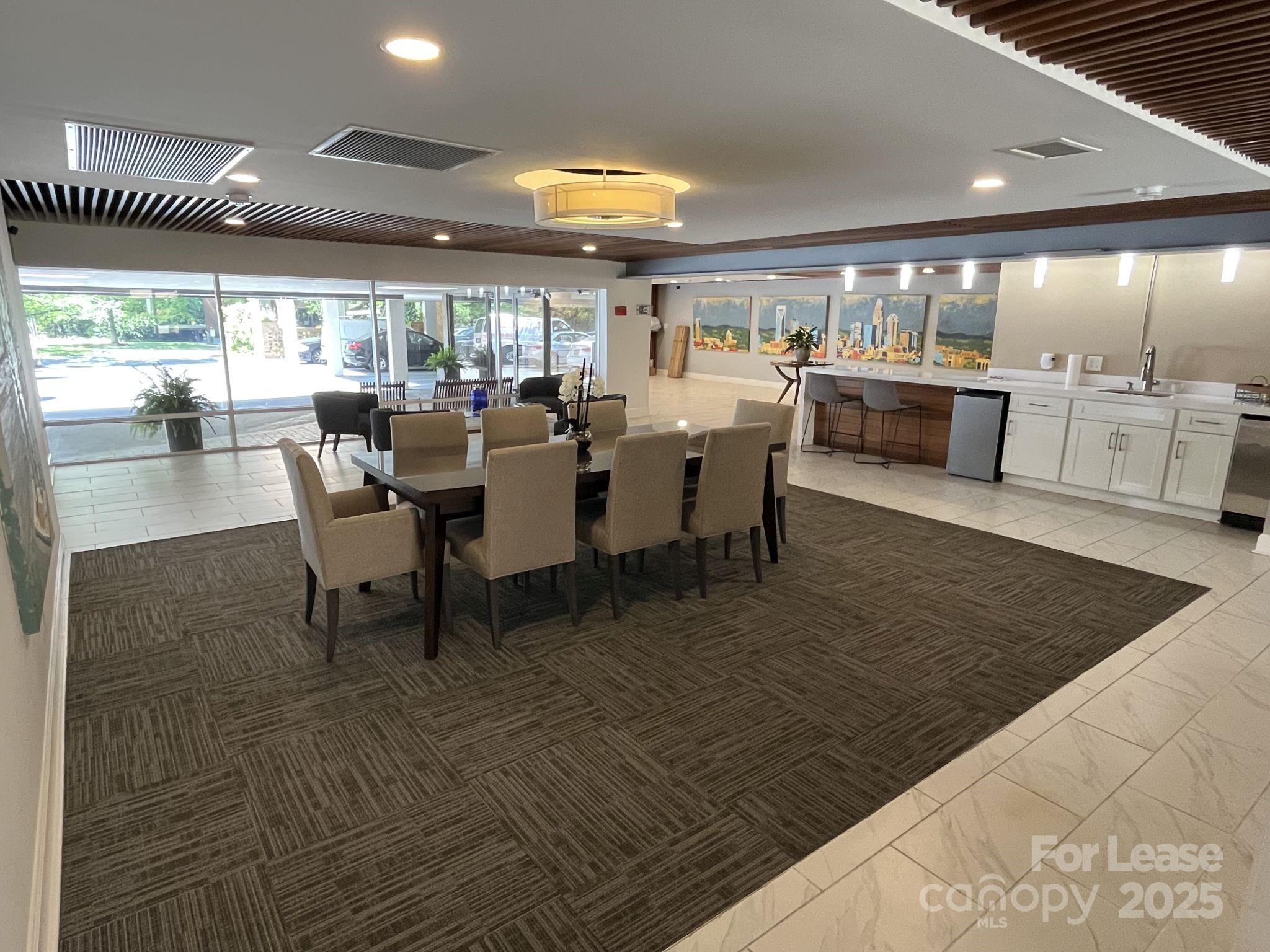 1323 Queens Road, Unit 312 Charlotte, NC 28207 - Photo 28 of 32 a dining hall with stainless steel appliances granite countertop a table and chairs