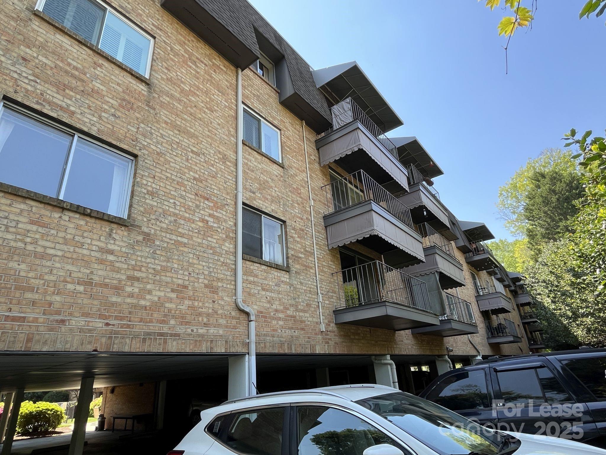 1323 Queens Road, Unit 312 Charlotte, NC 28207 - Photo 32 of 32 a front view of a house with parking space
