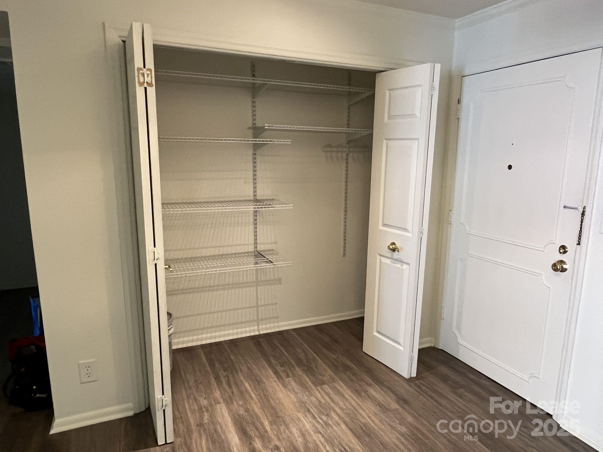 1323 Queens Road, Unit 312 Charlotte, NC 28207 - Photo 5 of 32 an empty room with wooden floor