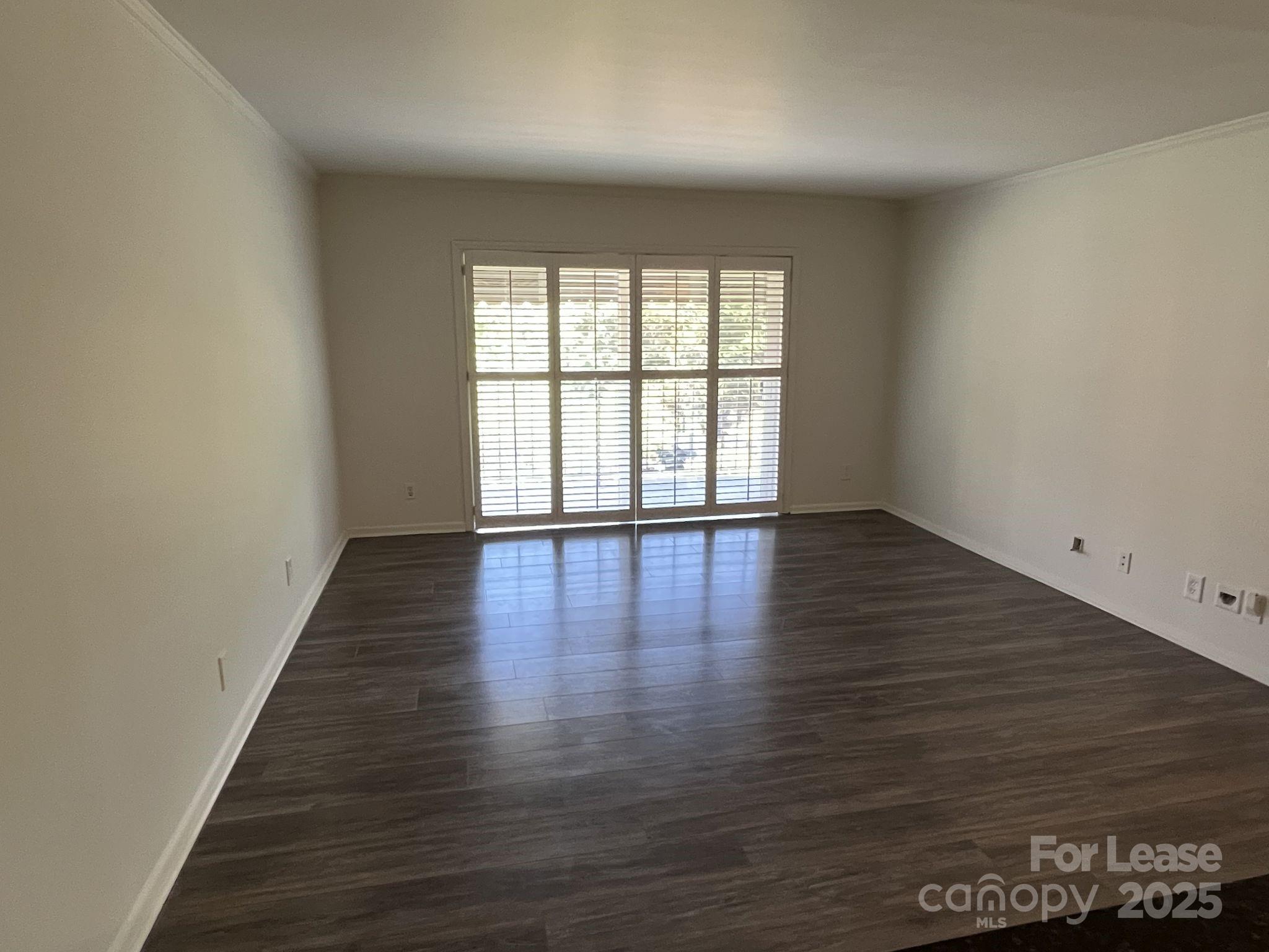 1323 Queens Road, Unit 312 Charlotte, NC 28207 - Photo 10 of 32 wooden floor in an empty room with a window