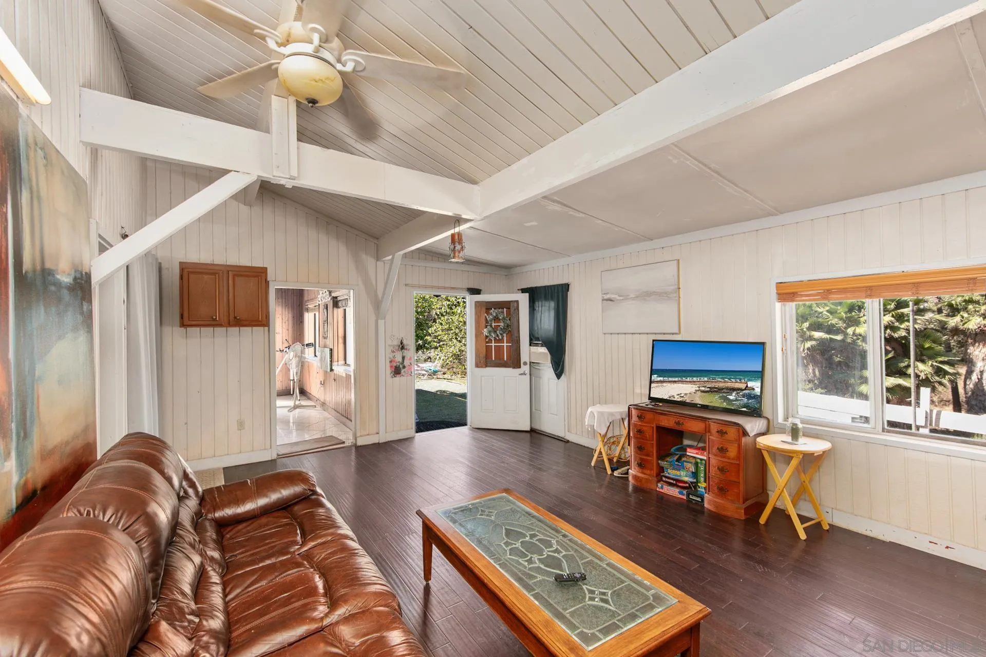 a living room with furniture and a flat screen tv