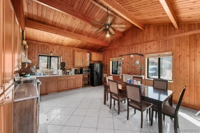 a dining area with furniture and a kitchen view