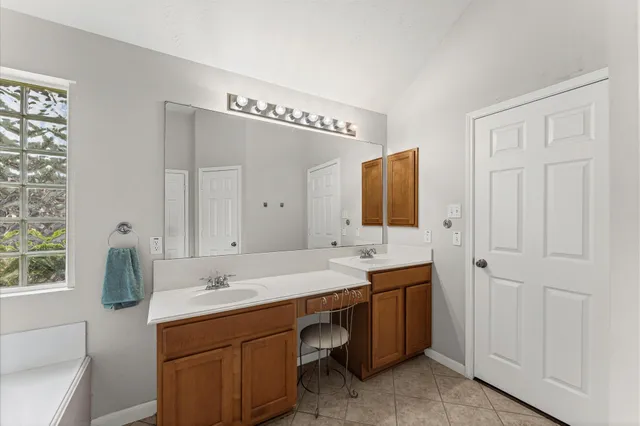 a spacious bathroom with a double vanity sink and a mirror