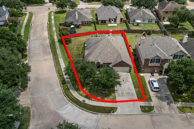 an aerial view of house with outdoor space and swimming pool