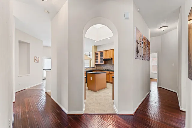 a view of a hallway with wooden floor and workspace