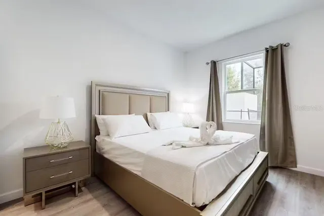 a bathroom with a granite countertop sink a mirror and a potted plant
