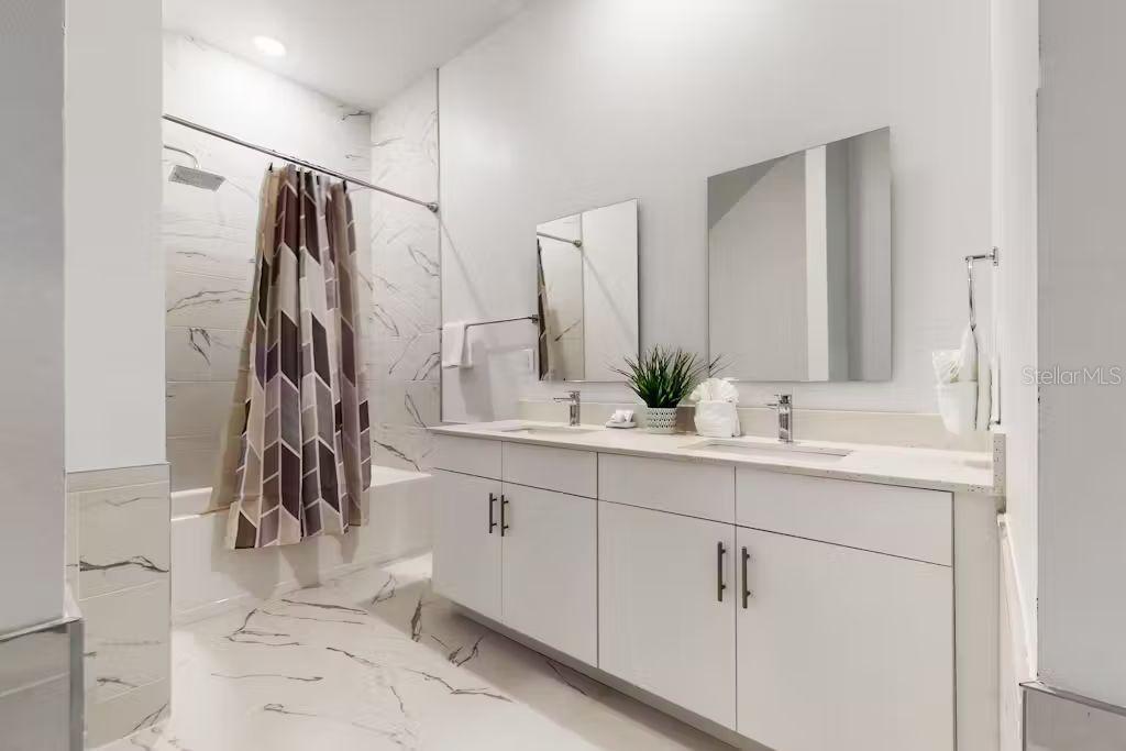 372 Famagusta Drive Davenport, FL 33896 - Photo 13 of 38 a bathroom with a double sink sink and a mirror