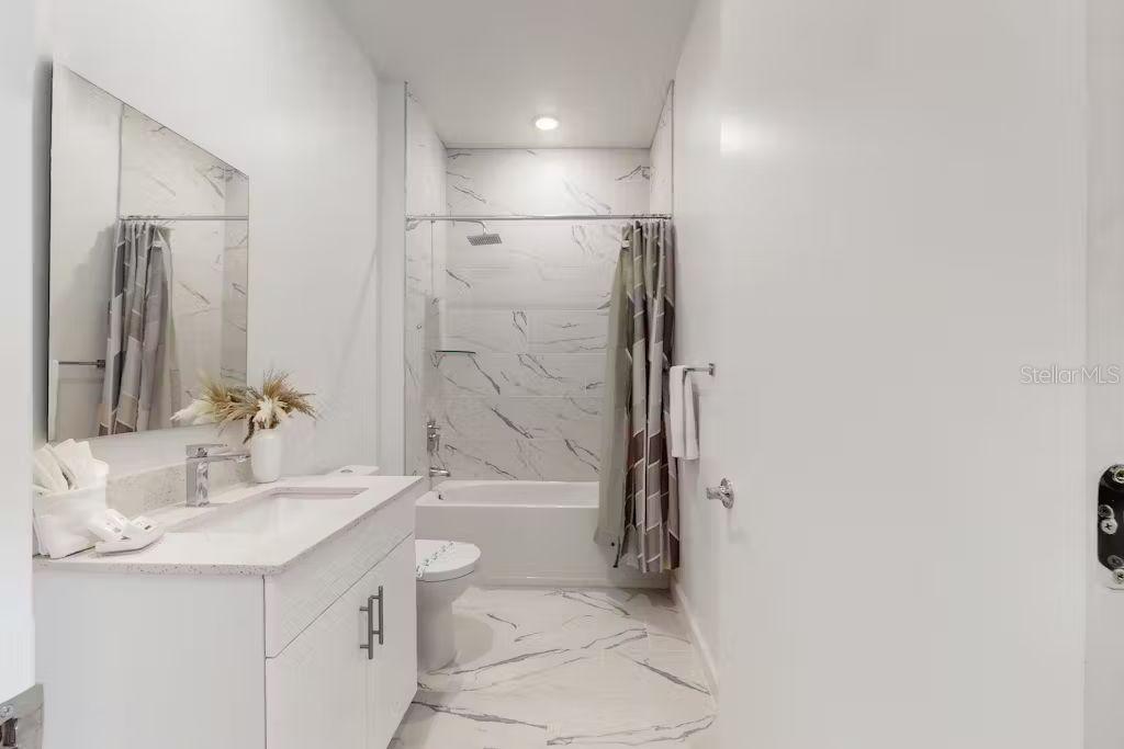 372 Famagusta Drive Davenport, FL 33896 - Photo 22 of 38 a bathroom with a granite countertop sink a toilet and shower