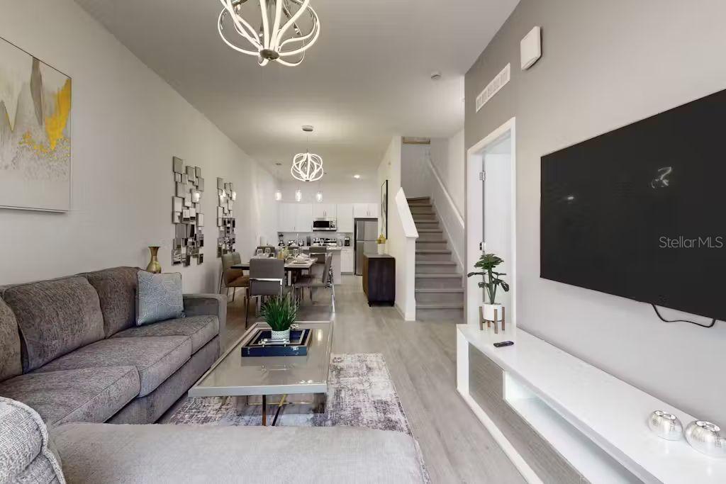 372 Famagusta Drive Davenport, FL 33896 - Photo 3 of 38 a living room with furniture and a chandelier