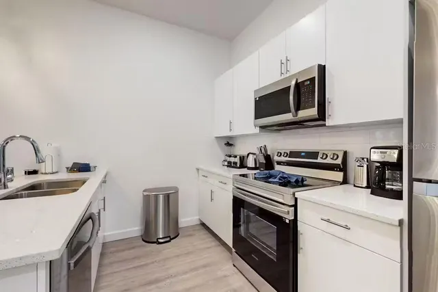a bedroom with a bed and a flat tv screen on dresser