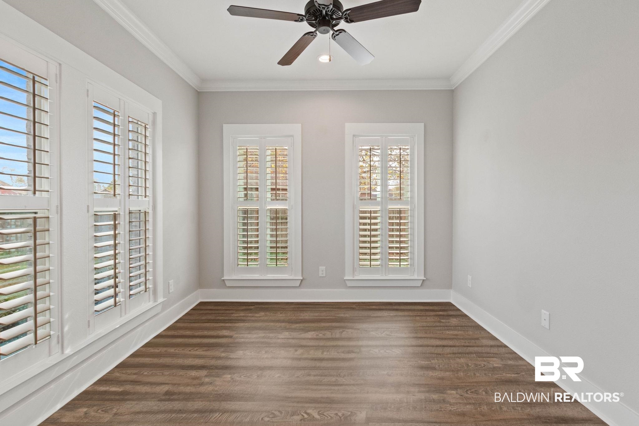 17376 Bankhead Boulevard Fairhope, AL 36532 - Photo 32 of 73 Spare room with ornamental molding, dark wood-style floors, and a ceiling fan