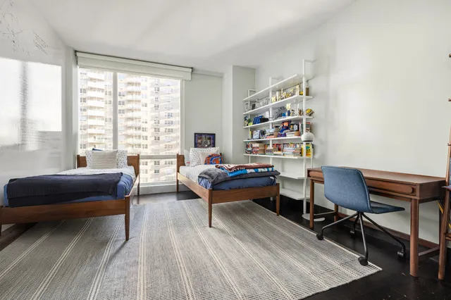 a bedroom with bed and wooden floor