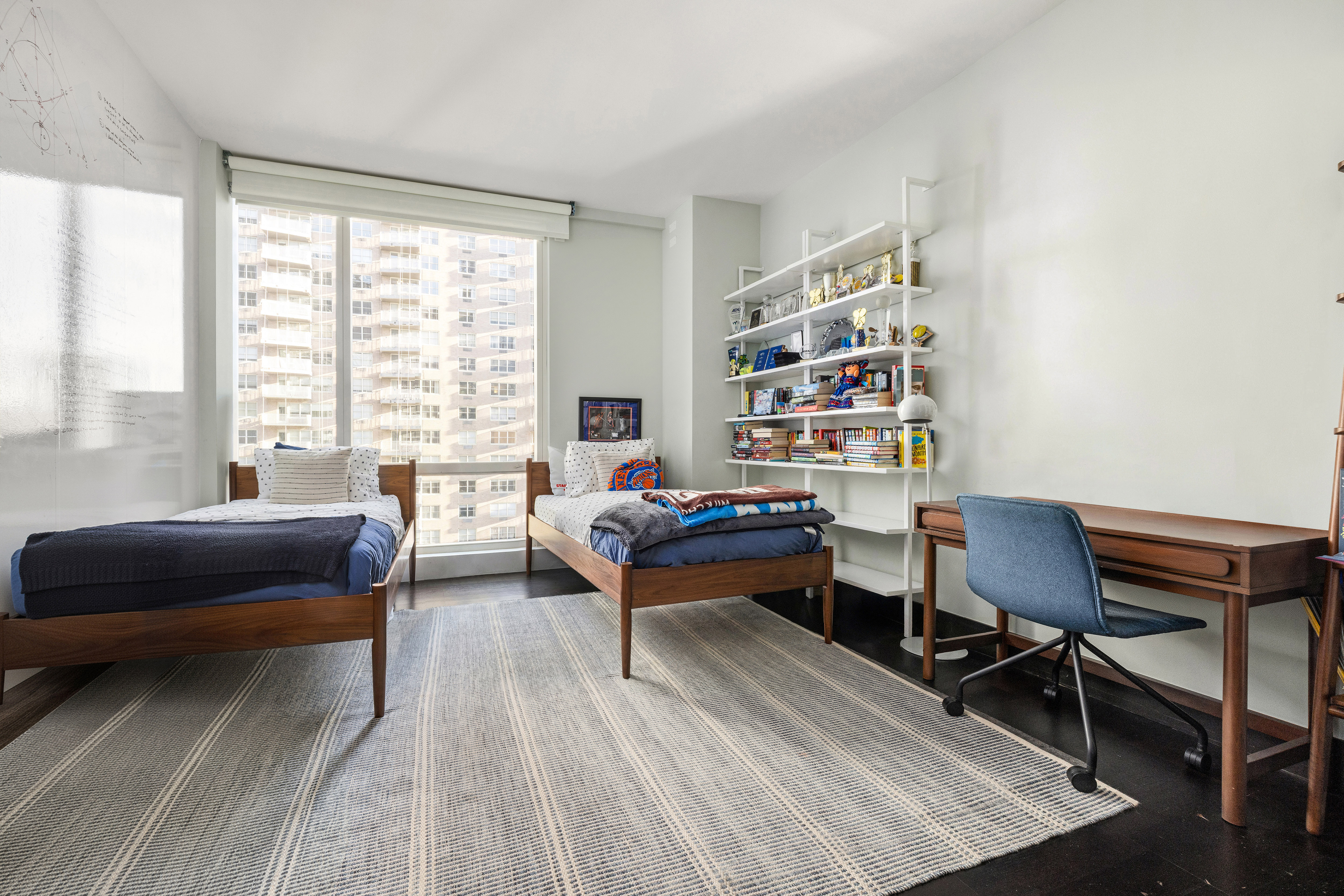 151 East 85th Street, Unit 11C Manhattan, NY 10028 - Photo 12 of 13 a living room with furniture a rug and a large window