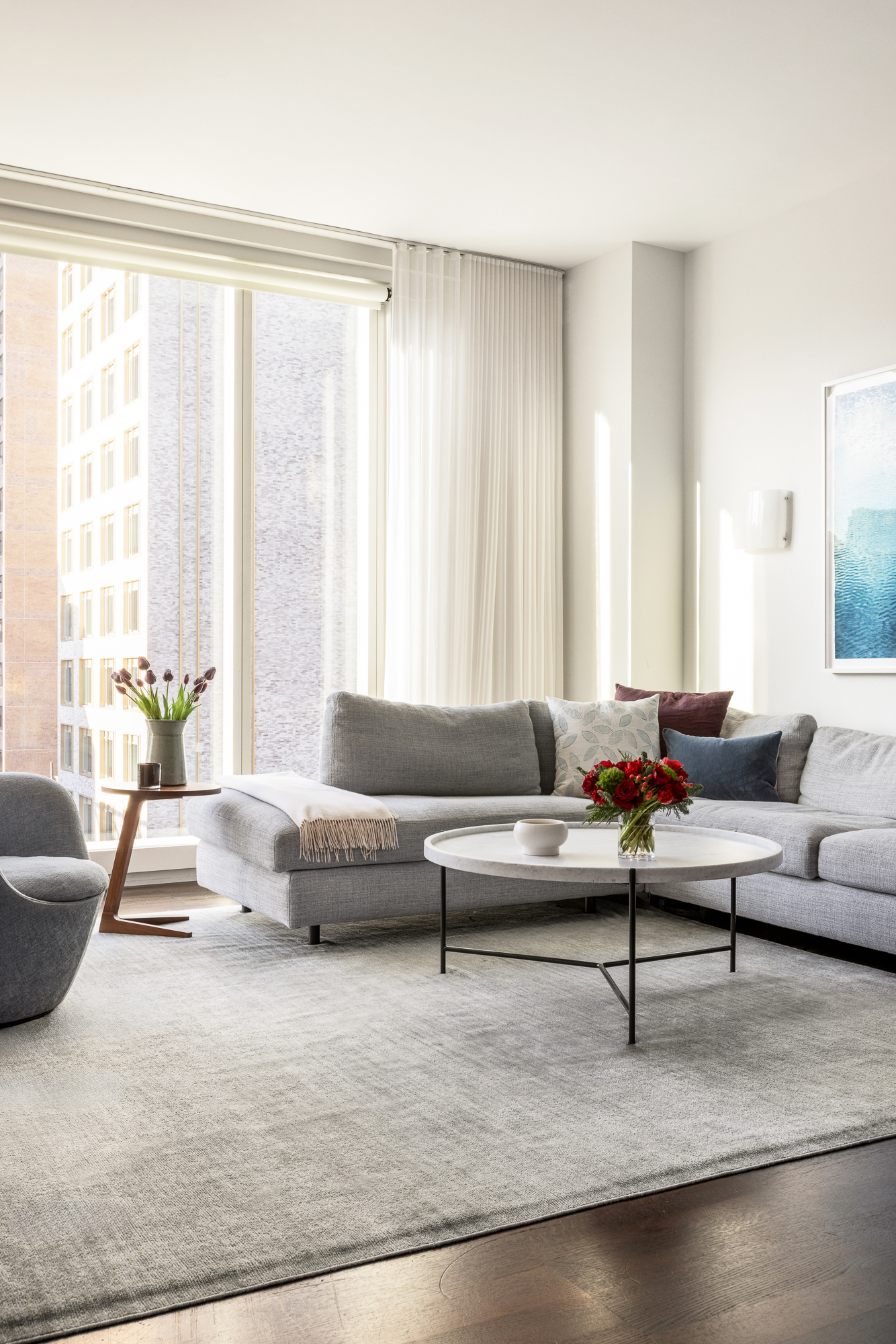 151 East 85th Street, Unit 11C Manhattan, NY 10028 - Photo 3 of 13 a living room with furniture and a large window