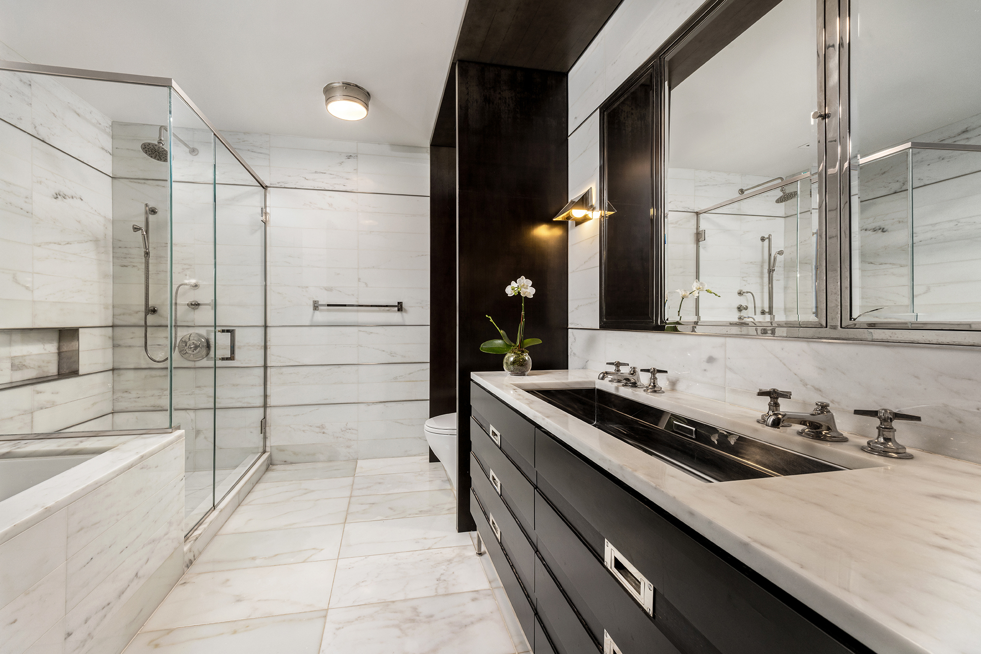 151 East 85th Street, Unit 11C Manhattan, NY 10028 - Photo 8 of 13 a bathroom with a tub a sink and a mirror