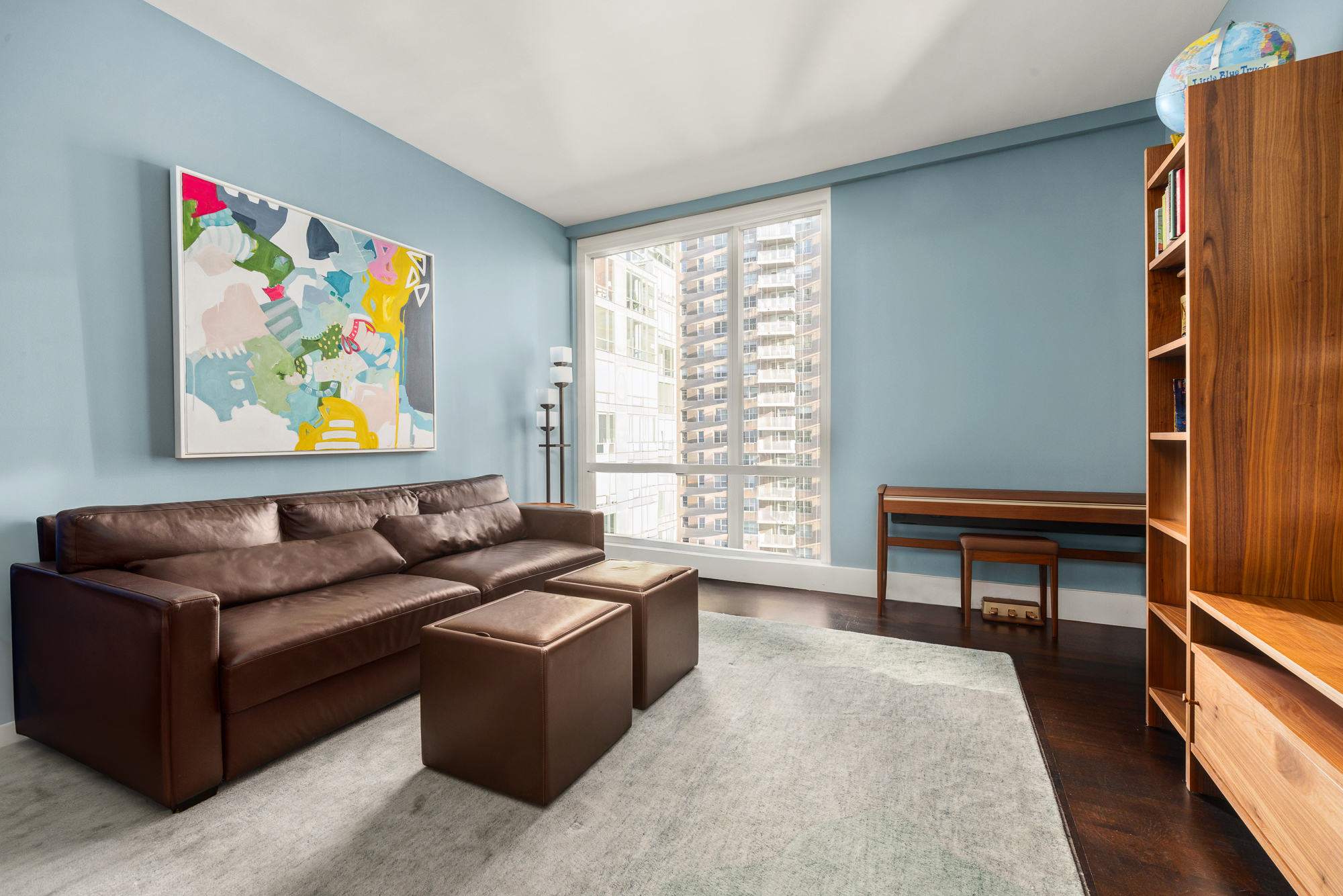 151 East 85th Street, Unit 11C Manhattan, NY 10028 - Photo 9 of 13 a living room with furniture and a window