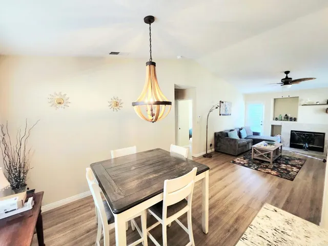 a living room with furniture rug and wooden floor