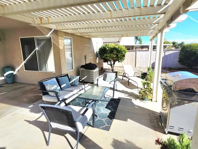 a view of a patio with table and chairs and potted plants