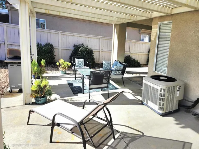 a view of a patio with table and chairs and potted plants