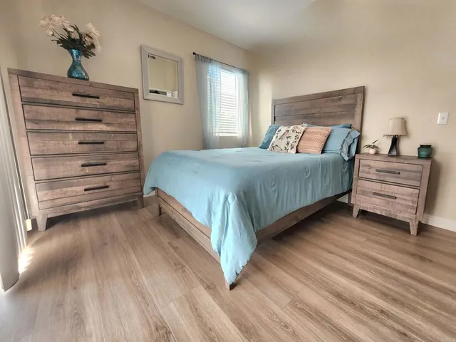 a bedroom with a bed and a mirror