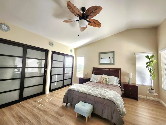 a bedroom with a bed and a large window