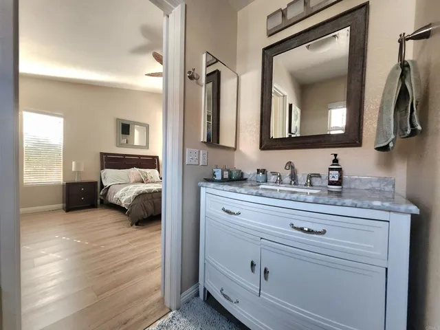 a spacious bedroom with a bed and a chandelier