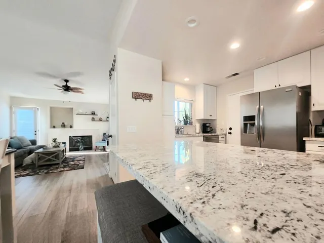 a living room with fireplace furniture and a large window