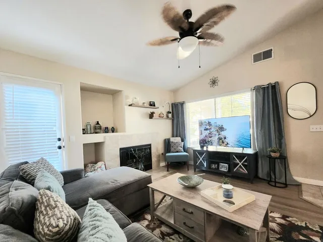 a living room with furniture and a chandelier