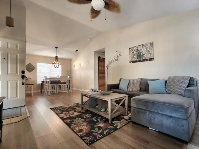 a living room with furniture and wooden floor