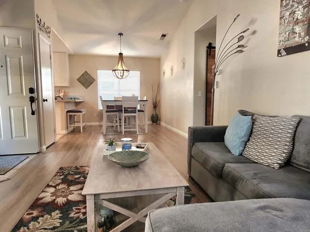 a view of a kitchen with wooden floor and windows