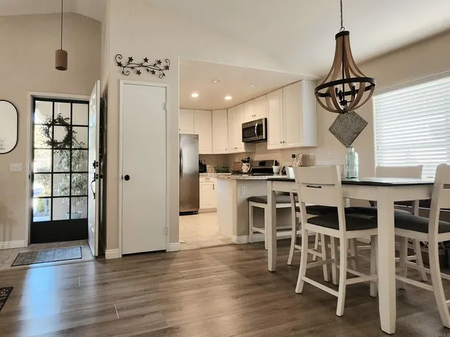 a living room with furniture a wooden floor and a chandelier