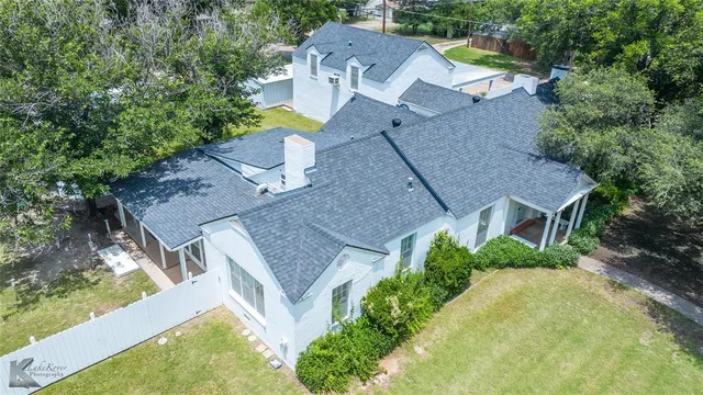 an aerial view of a house with a garden and swimming pool