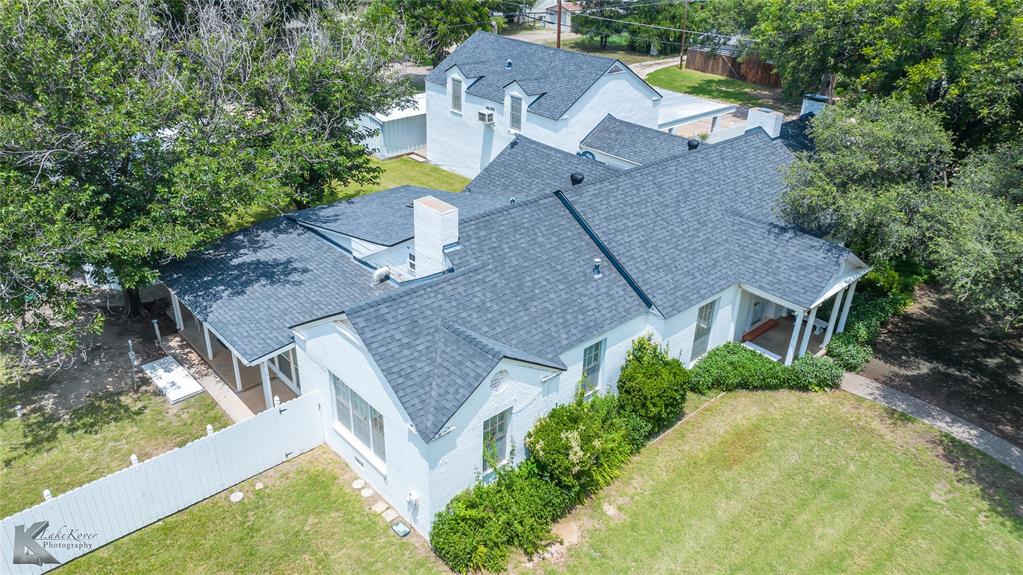 an aerial view of a house with a garden and swimming pool