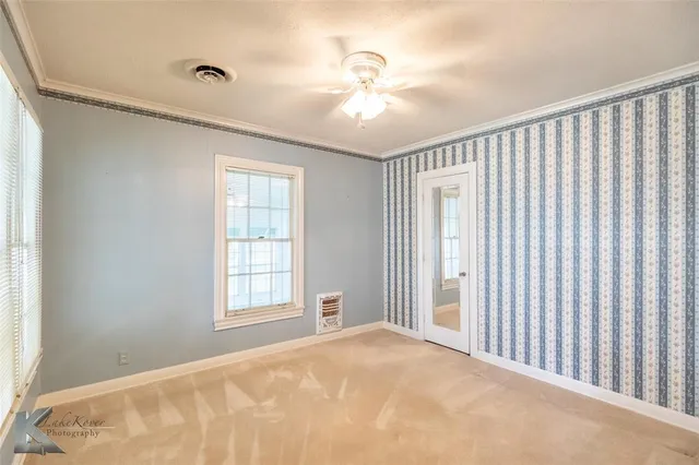 a view of an empty room with a window