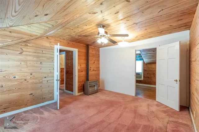 en empty room with closet and chandelier fan