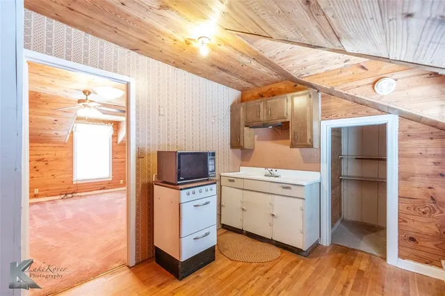 a kitchen with a stove a sink and a refrigerator