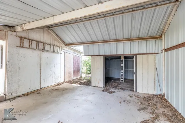 a view of a house with wooden wall and roof